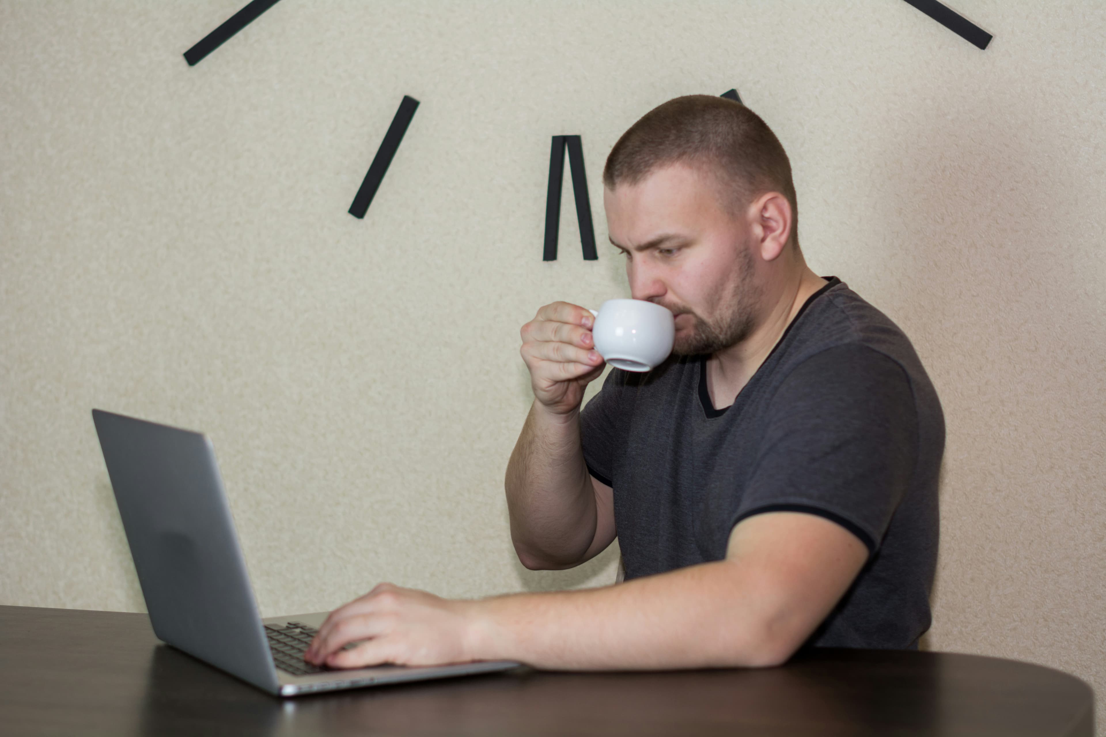 Man With Laptop Drinking Coffee
