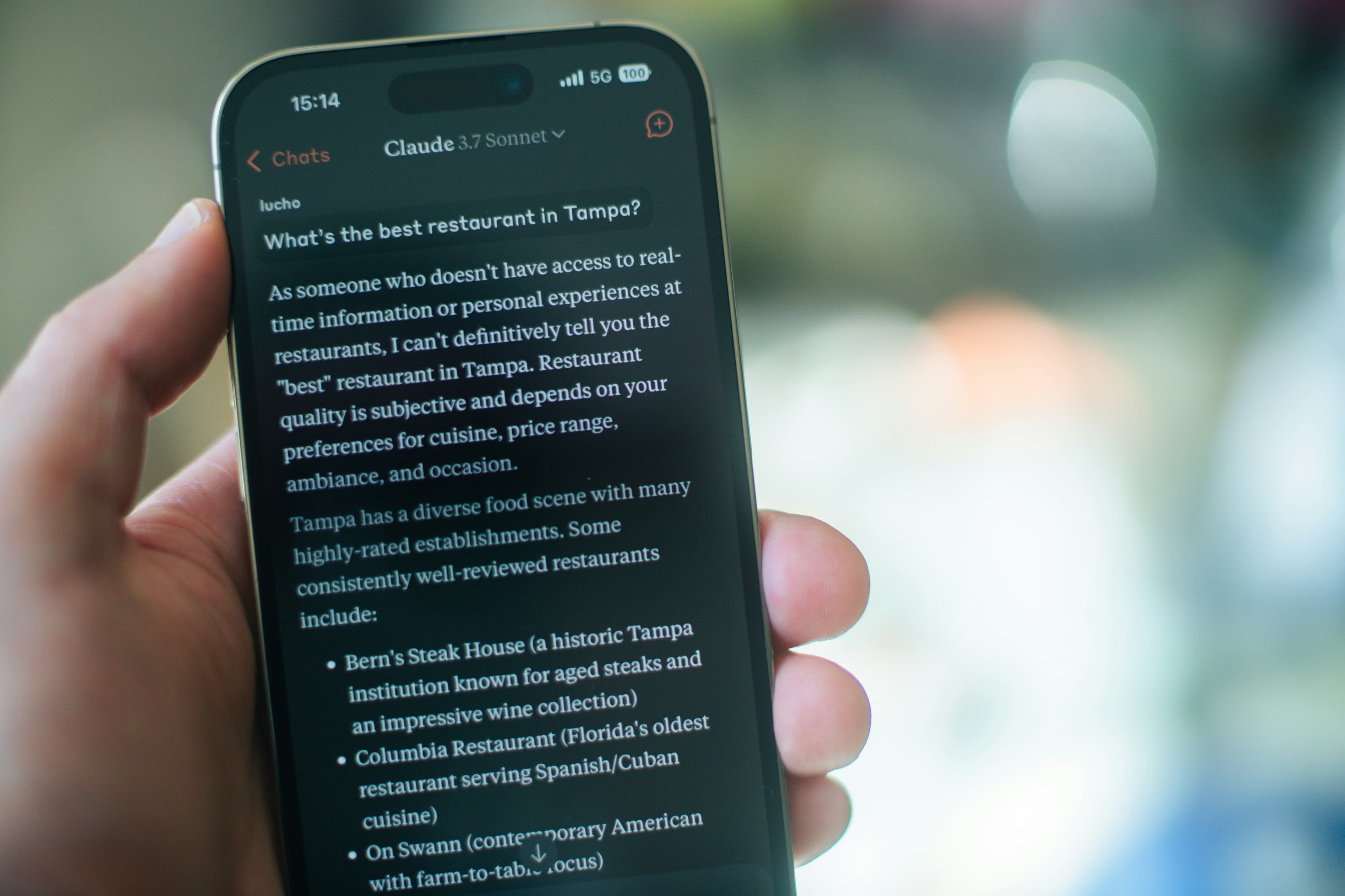 Mobile Phone Showing Claude Discussion